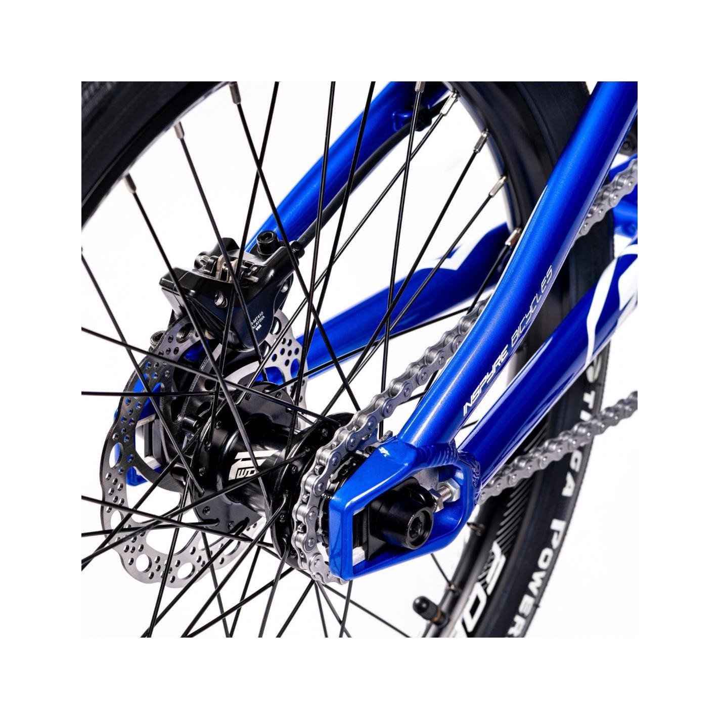 A close up of a blue Inspyre Evo Disc Expert Bike with a chain.