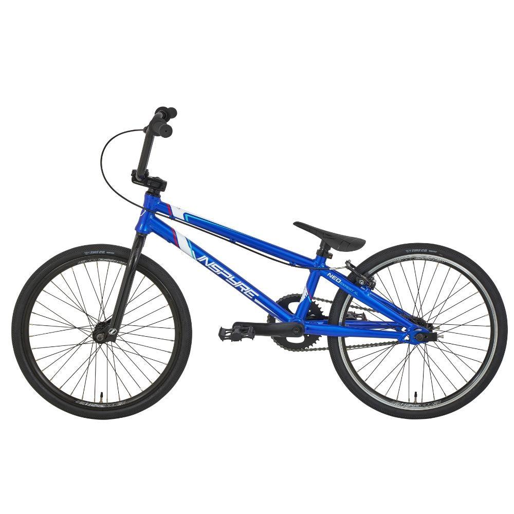 The Inspyre Neo Expert Bike 2025 is a blue entry-level BMX with black tires, black handlebars, and a low seat—shown in side profile on a white background—making it ideal as a kid's first race bike.