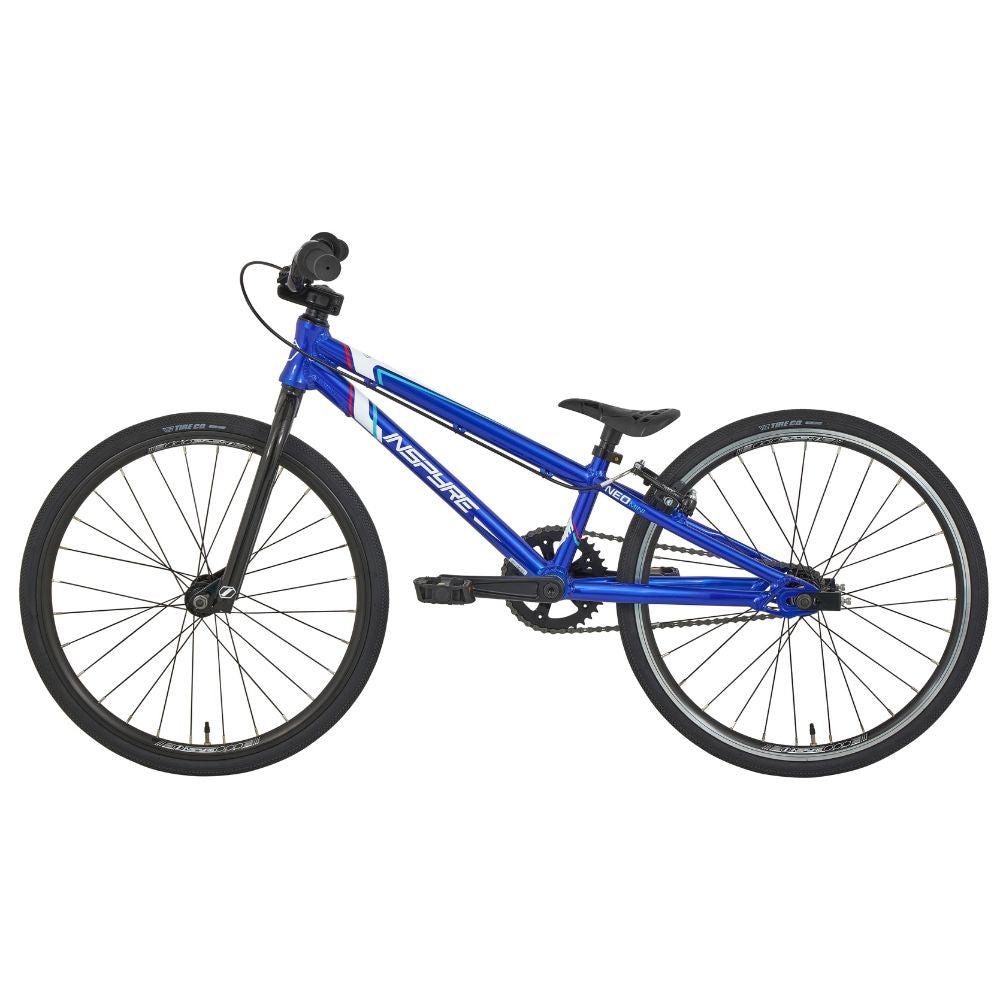 The Inspyre Neo Mini Bike 2025 is a blue entry-level race bike with a lightweight frame, black handlebars, and two large black wheels, shown from the side against a white background—ideal for kids BMX racing.