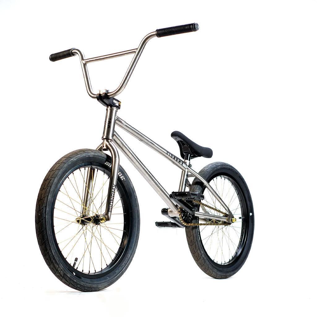 ION BMX TiXX 20 Inch Bike with a titanium frame, gold-colored spokes, black tires, and a single seat.