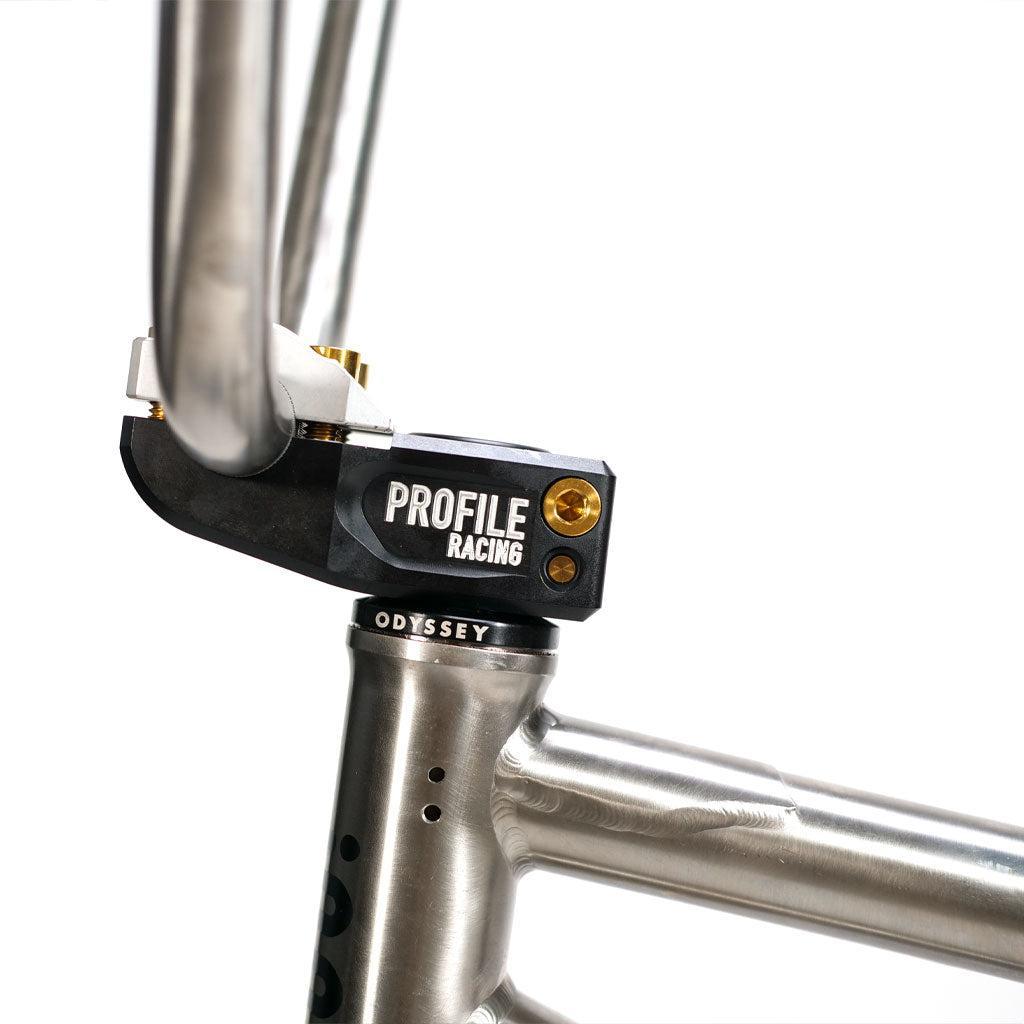 Close-up of a black BMX handlebar stem connected to the silver head tube of an ION BMX TiXX 20 Inch Bike, featuring visible branding on both parts.