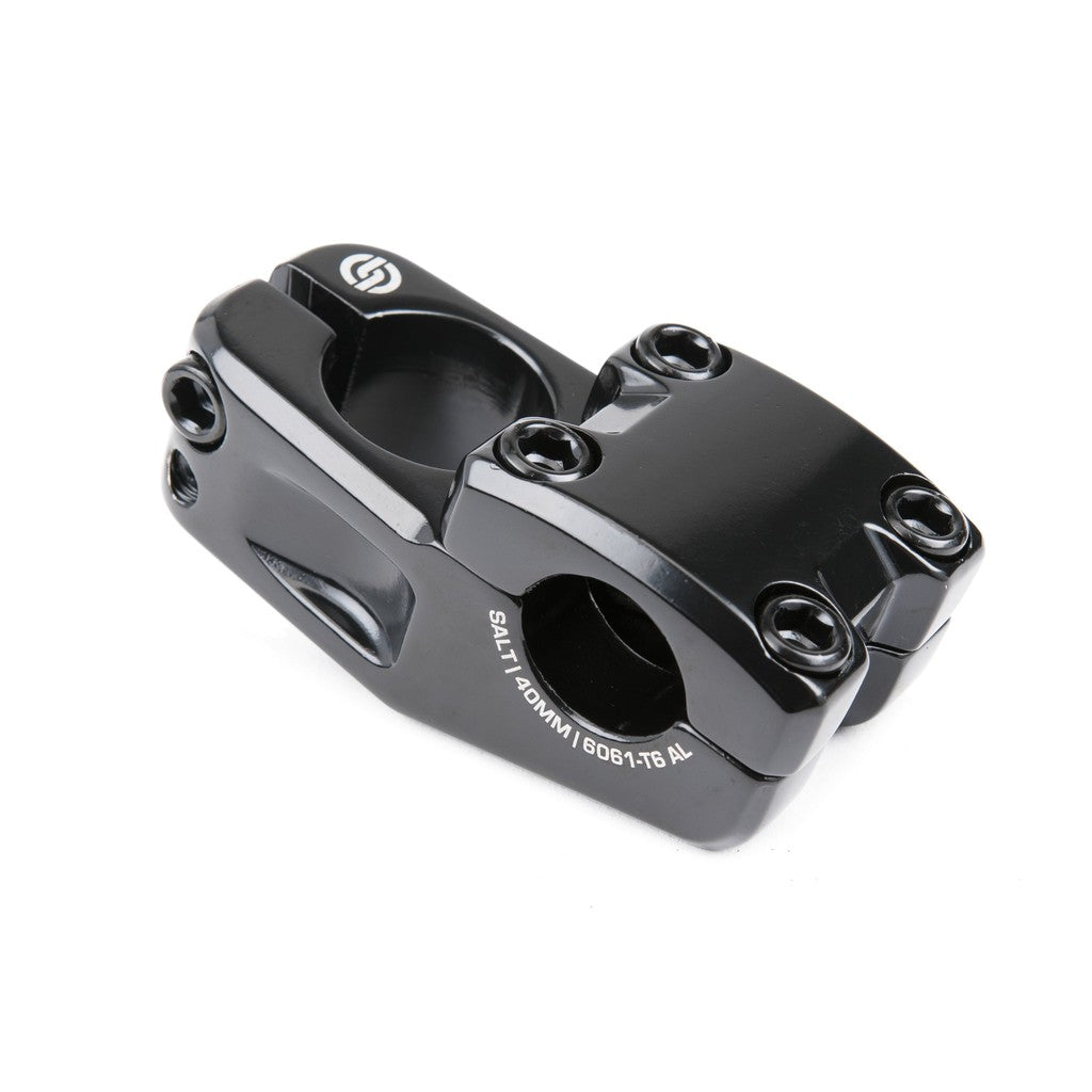 The Junior Top Load Stem 1-1/8th Inch (22.2mm Clamp) is a black BMX bike stem made from robust 6061-T6 alloy, featuring four front bolts and two side bolts for secure installation. With the Salt logo and size specifications printed on the side, this top load stem provides a dependable fit and a 40mm reach for improved control.
