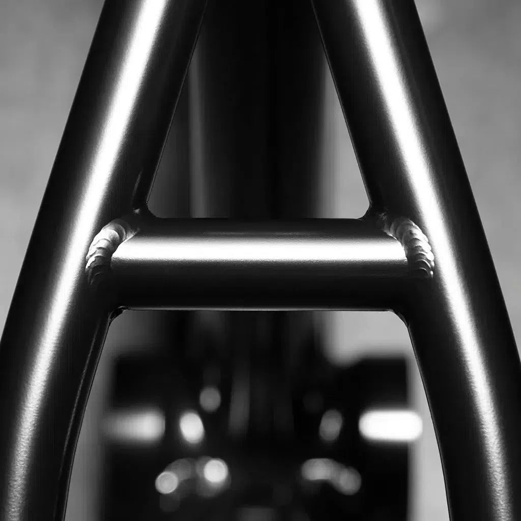 Close-up of a metallic joint with welds forming an "A", part of the Kink Cloud Frame (Travis Hughes). This robust build features durable chromoly tubing, ideal for street riding adventures.