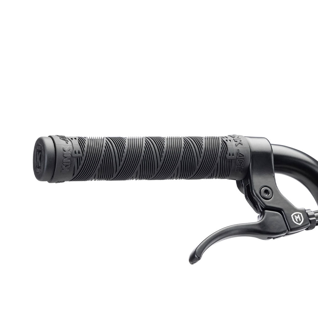 Close-up image of a black bicycle handlebar grip with a textured surface, featuring an attached brake lever on the right side—perfect for the Kink Curb 20 Inch Bike or any BMX equipped with 20-inch bike components.