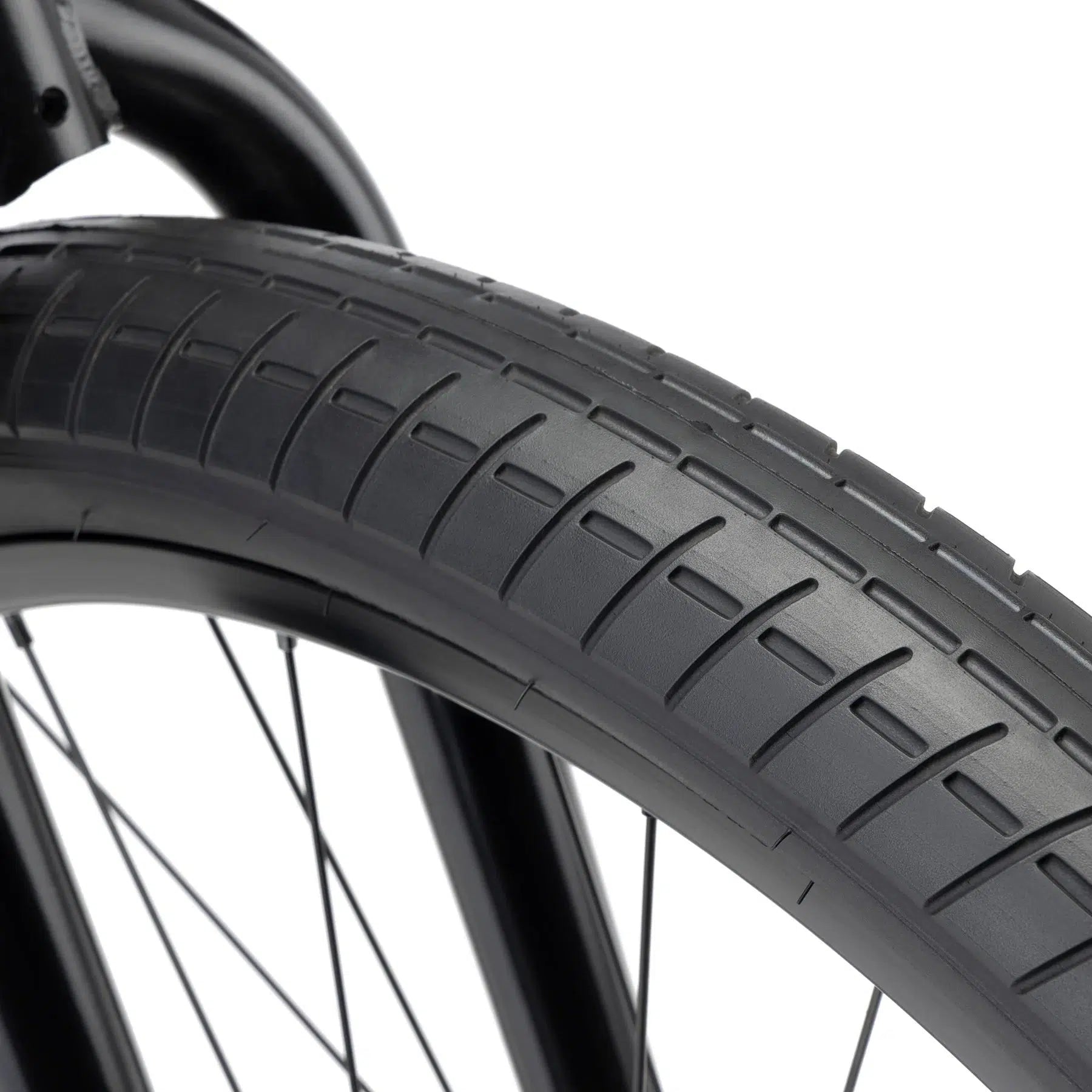 Close-up of a Kink Drifter 26 Inch Bike tire showing the tread pattern and part of the bicycle frame.