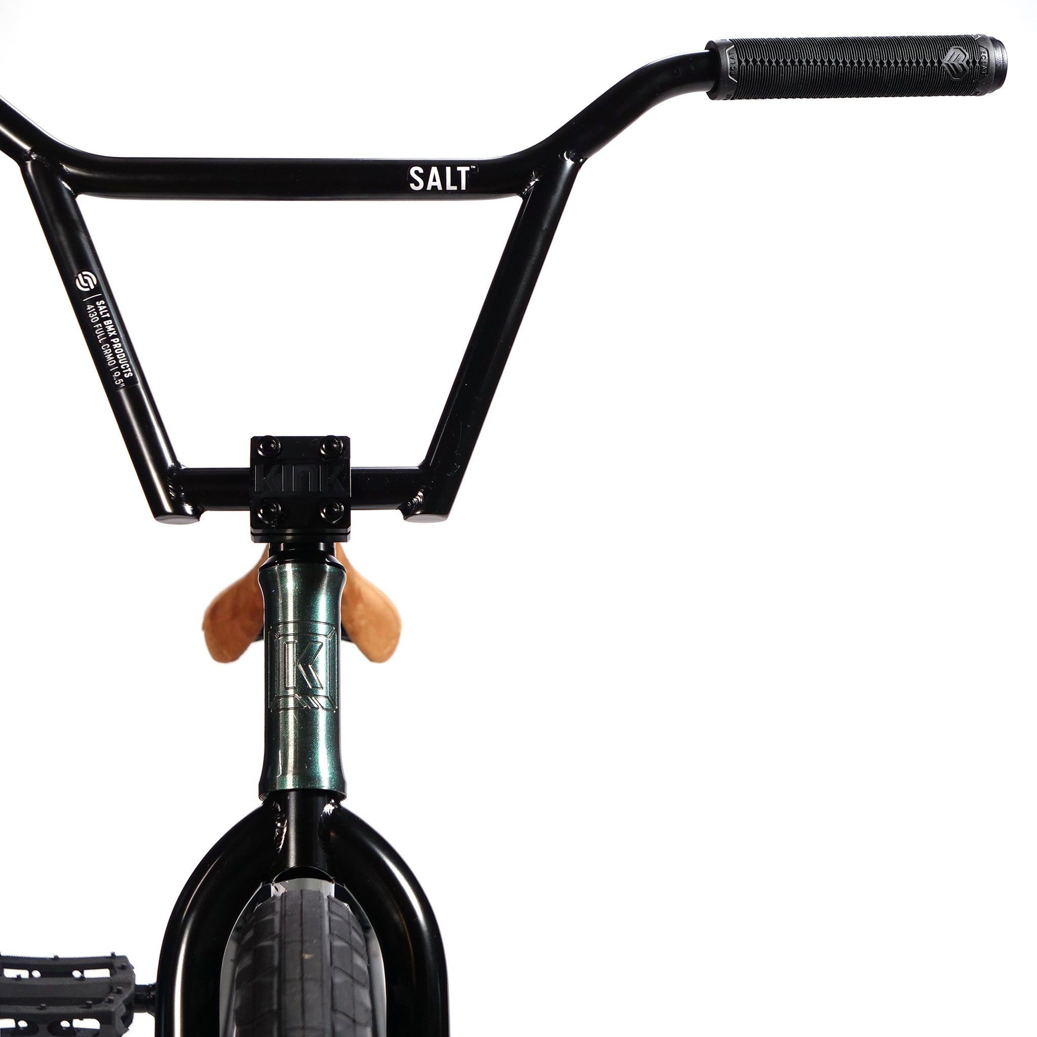 Close-up of the handlebars and front fork of a BMX bike, displaying the brand names "Salt" on the handlebars and "Kink" on the front fork. Featuring a Kink Tactic Custom 20 Inch Bike, this budget-friendly custom build from LUXBMX is viewed from the front against a white background.