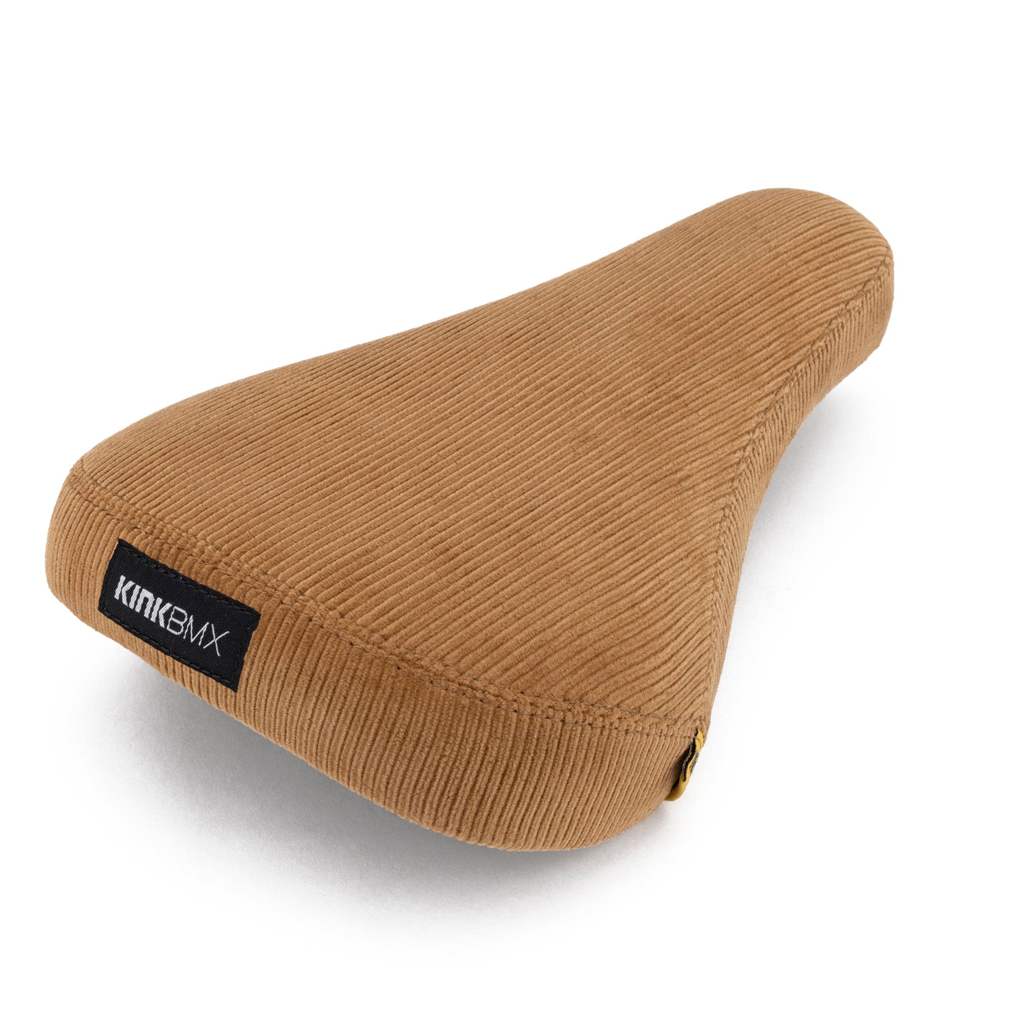 A brown corduroy bicycle seat with a textured surface is shown at a slight angle. The brand name "KINK BMX" is visible on a black tag on the side, highlighting its Kink Williams Stealth Pivotal Seat design.
