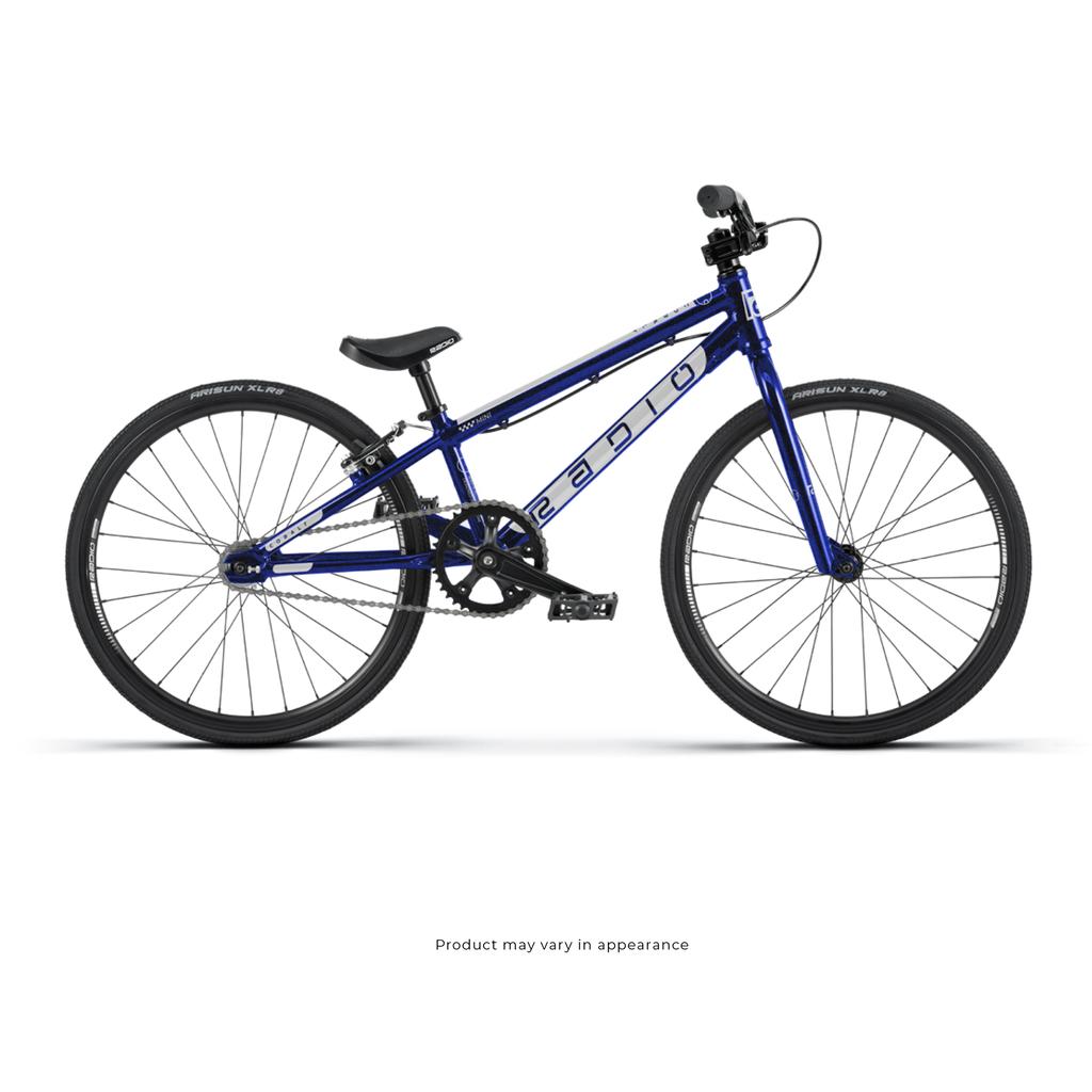 The Radio Cobalt Mini Bike is a blue BMX-style bicycle with a lightweight frame, black handlebars, and thin tires, shown side-on against a white background—ideal as an entry-level race bike for new BMX riders.