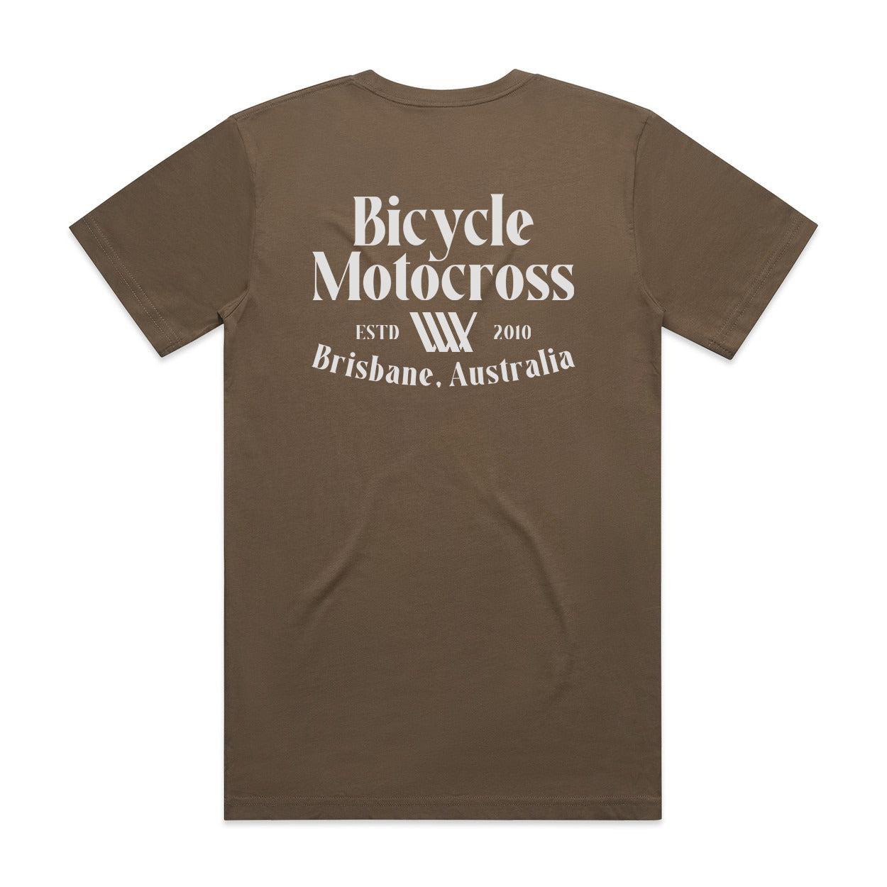 The LUXBMX Bicycle Motocross Tee Walnut, featuring white text on the back that reads "Bicycle Motocross ESTD 2010 Brisbane, Australia," is perfect for any BMX enthusiast. This walnut brown T-shirt is a stylish nod to your cycling passion.