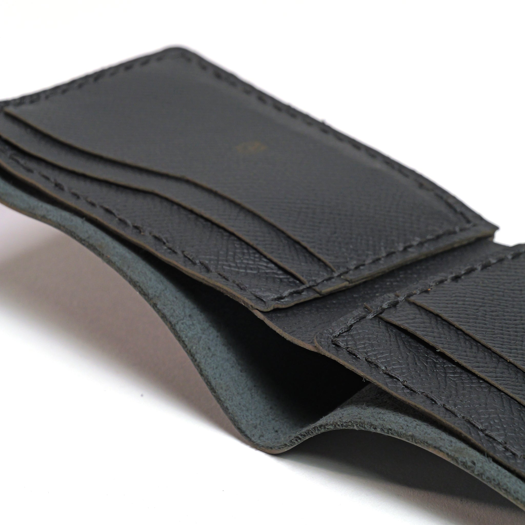 Close-up of the LUXBMX Bifold Leather Wallet, handmade in Queensland from full-grain leather, with visible stitching, multiple card slots, and an open pocket.