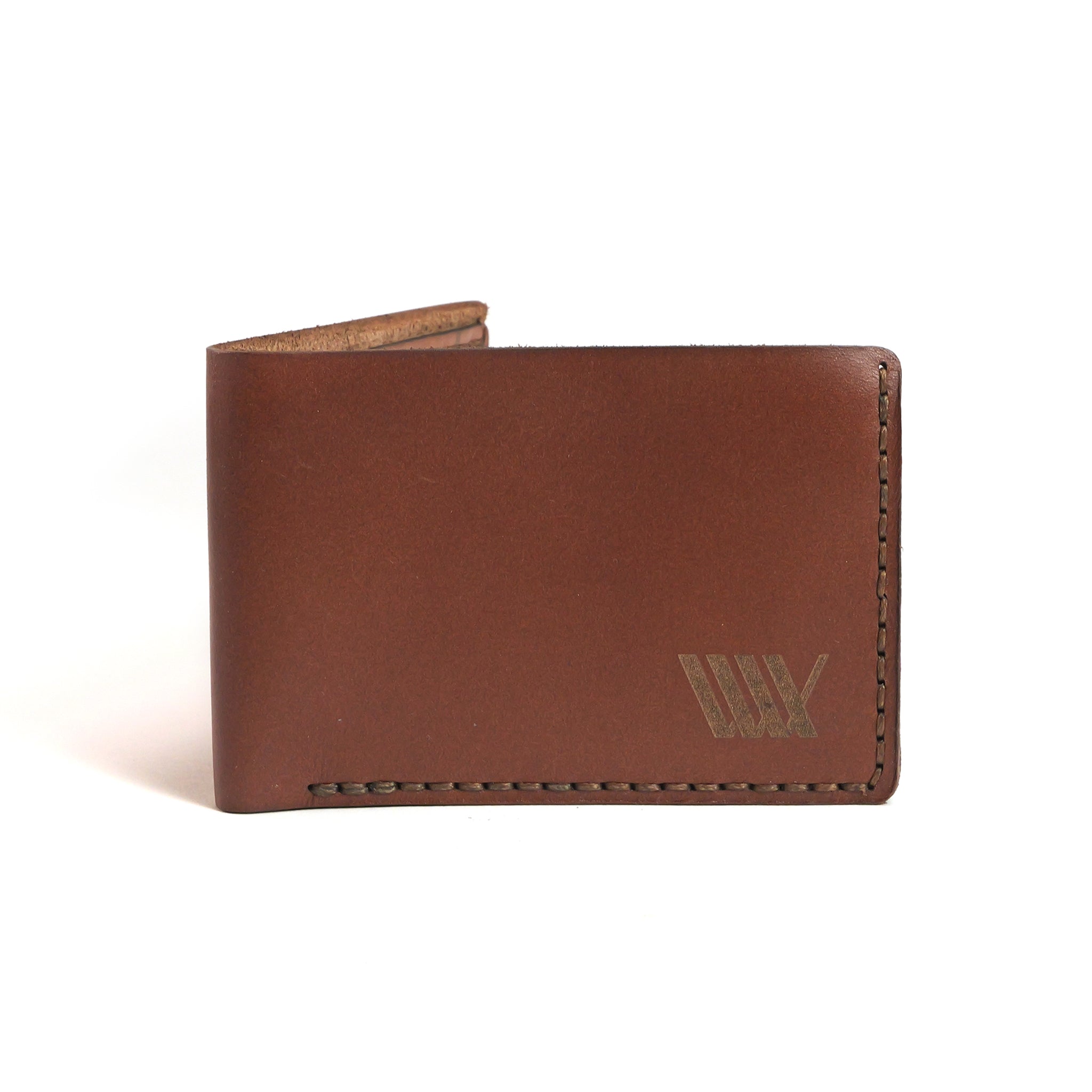 The LUXBMX Bifold Leather Wallet is a brown, handmade wallet crafted from full-grain leather in Queensland, featuring visible stitching and a small embossed logo in the lower right corner.