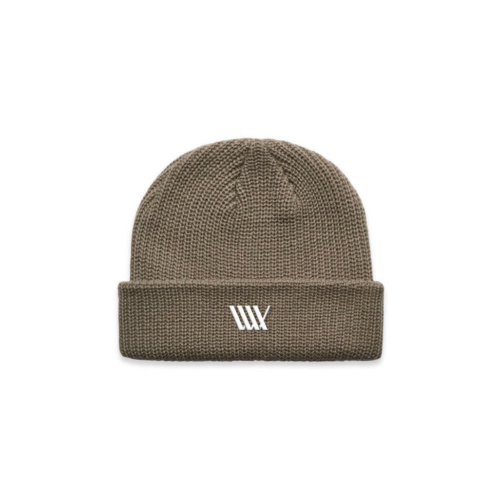 The LUXBMX Flag Beanie - Walnut is a brown knit beanie made from mid-weight acrylic, featuring a folded brim and a white embroidered LUXBMX flag logo on the front.
