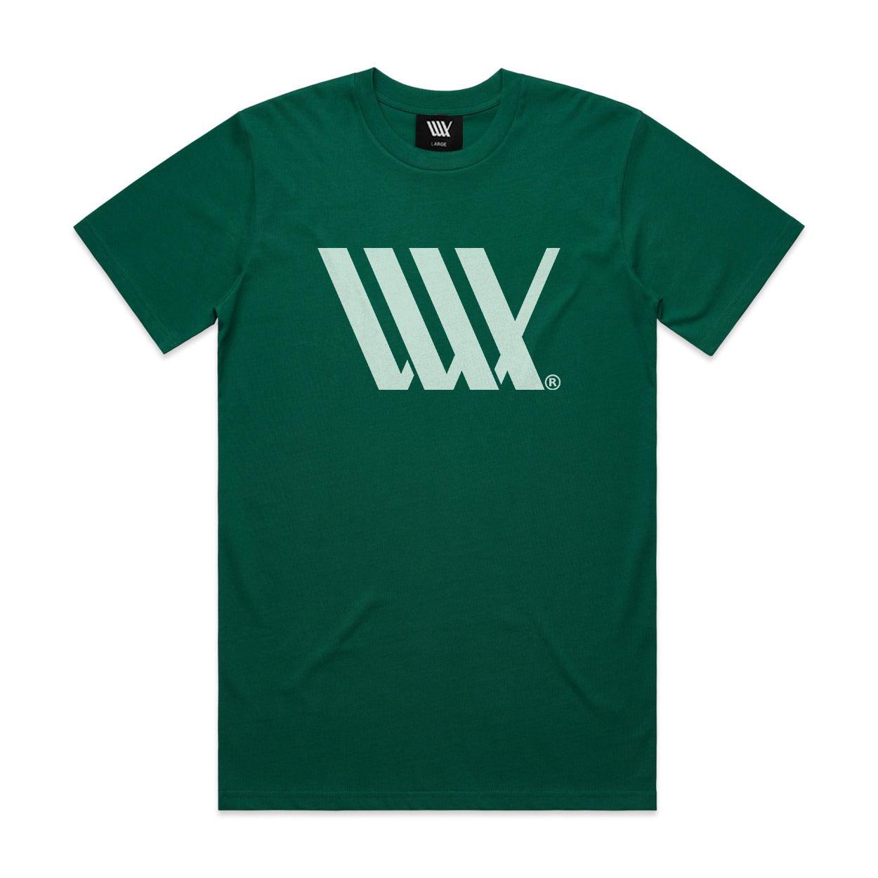 The LUXBMX Flag Tee Jade is a green heavyweight tee that features a striking large white graphic design with three overlapping "W" letters in the center.
