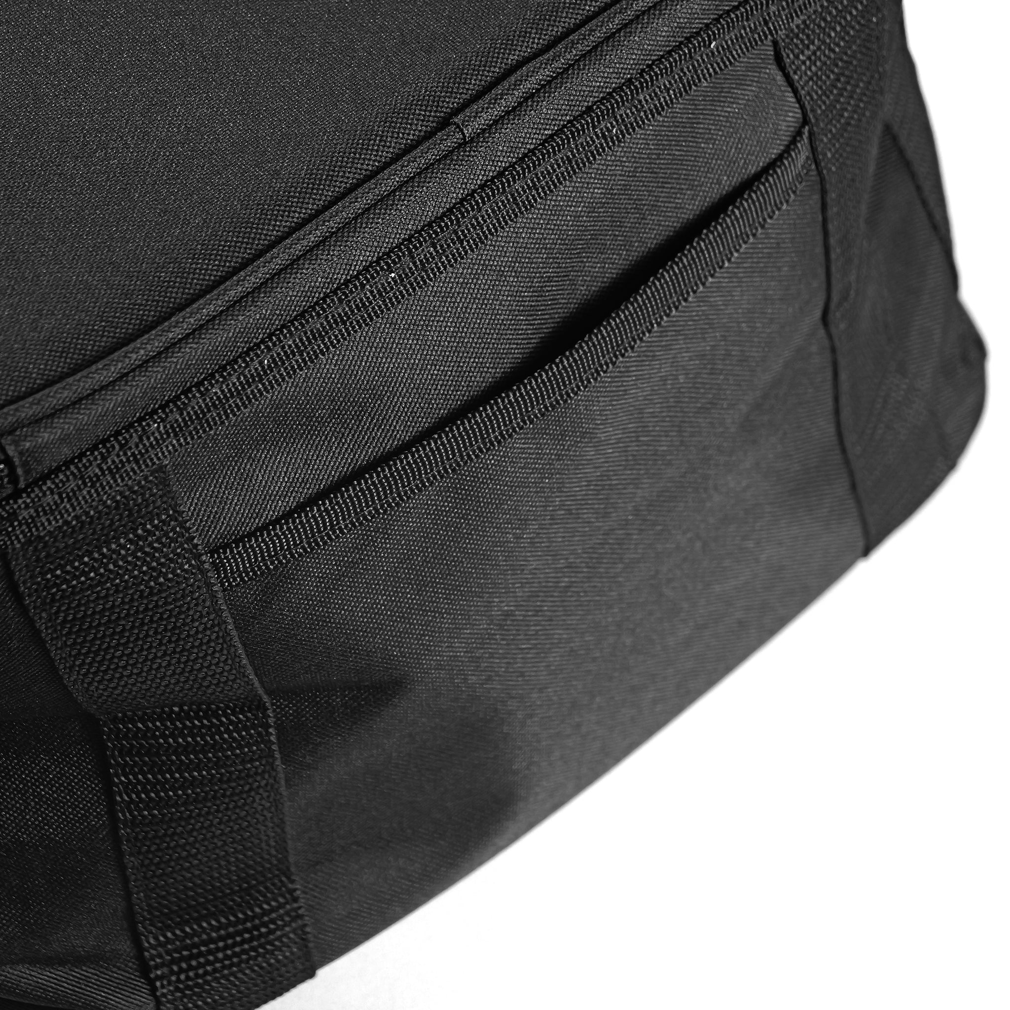 Close-up of the LUXBMX Journey Cooler Bag in black, showcasing padded insulation, a stitched front pocket, and reinforced seams against a white background.
