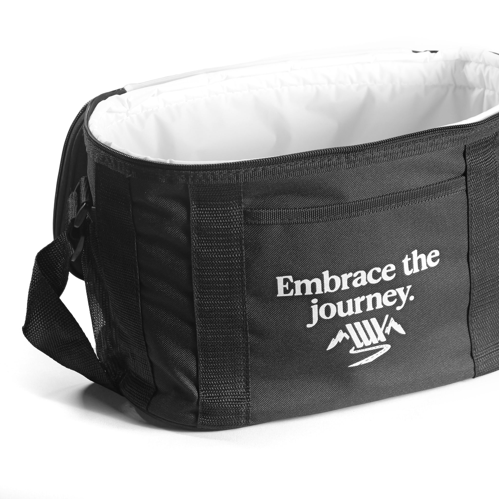 The LUXBMX Journey Cooler Bag is a black duffel with an adjustable shoulder strap, open top, and side pocket featuring "Embrace the journey." and a mountain graphic. Padded insulation keeps your items cool on any adventure.