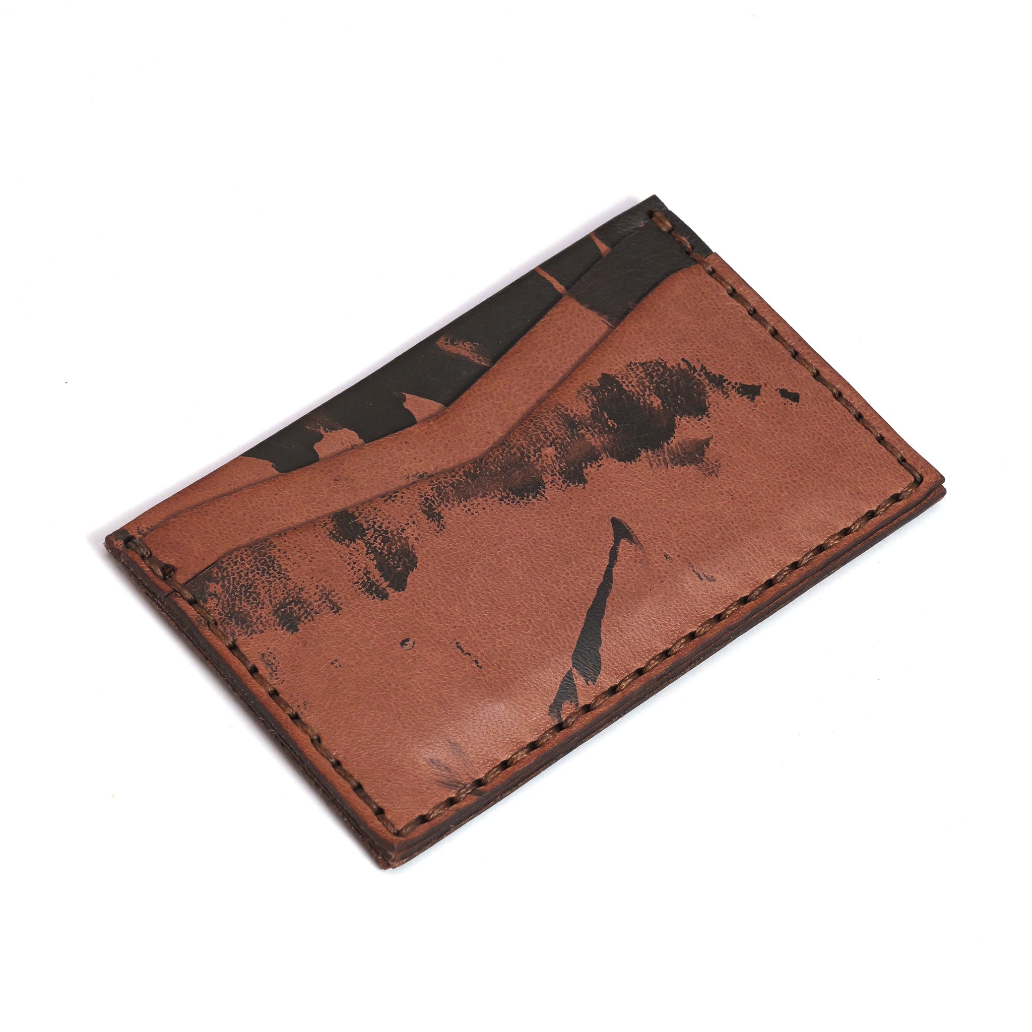 The LUXBMX Leather Card Holder is handmade in Queensland from brown full-grain leather, features black abstract markings, visible stitching, and a single card slot.