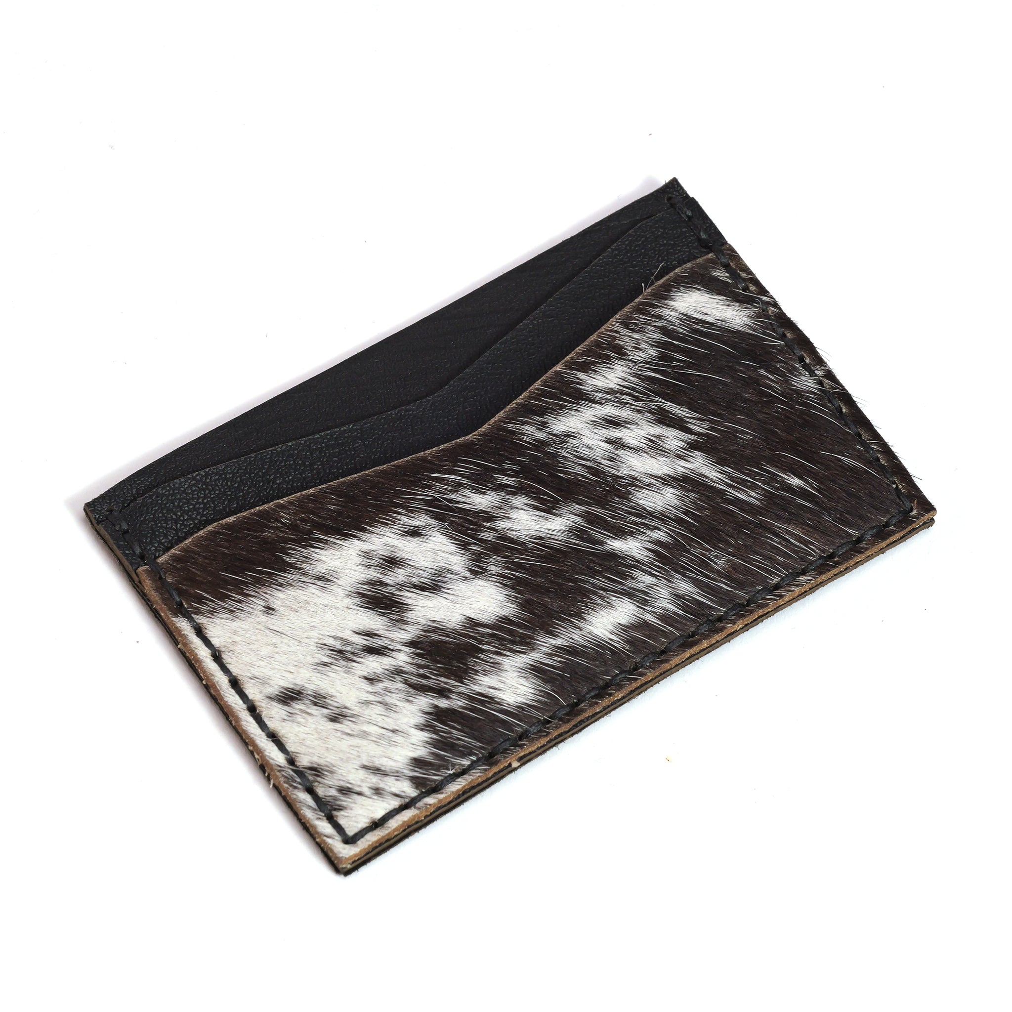 The LUXBMX Leather Card Holder is a minimalist, handmade card holder crafted from black leather and black-and-white cowhide—an ideal unique BMX accessory. Shown photographed on a white background.