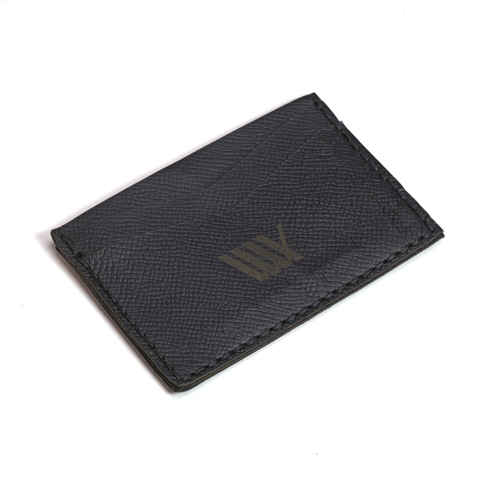 The LUXBMX Leather Card Holder is a black handmade piece with visible grain texture, stitched edges, and a subtle front logo—an elegant way to carry essentials or complement your favorite BMX gear.