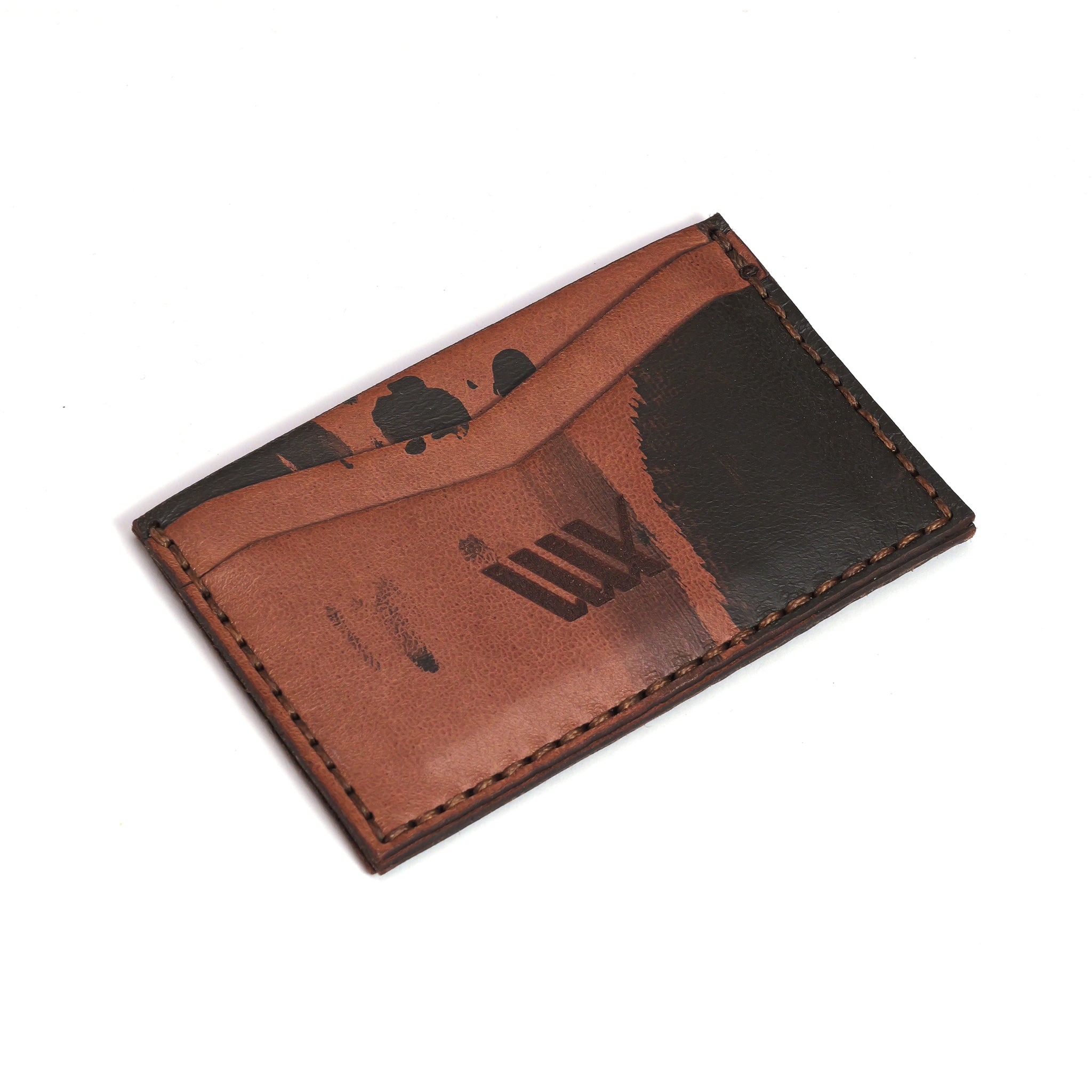 The LUXBMX Leather Card Holder, handmade in Queensland from brown full-grain leather with black abstract markings and visible stitching, is shown on a white background.