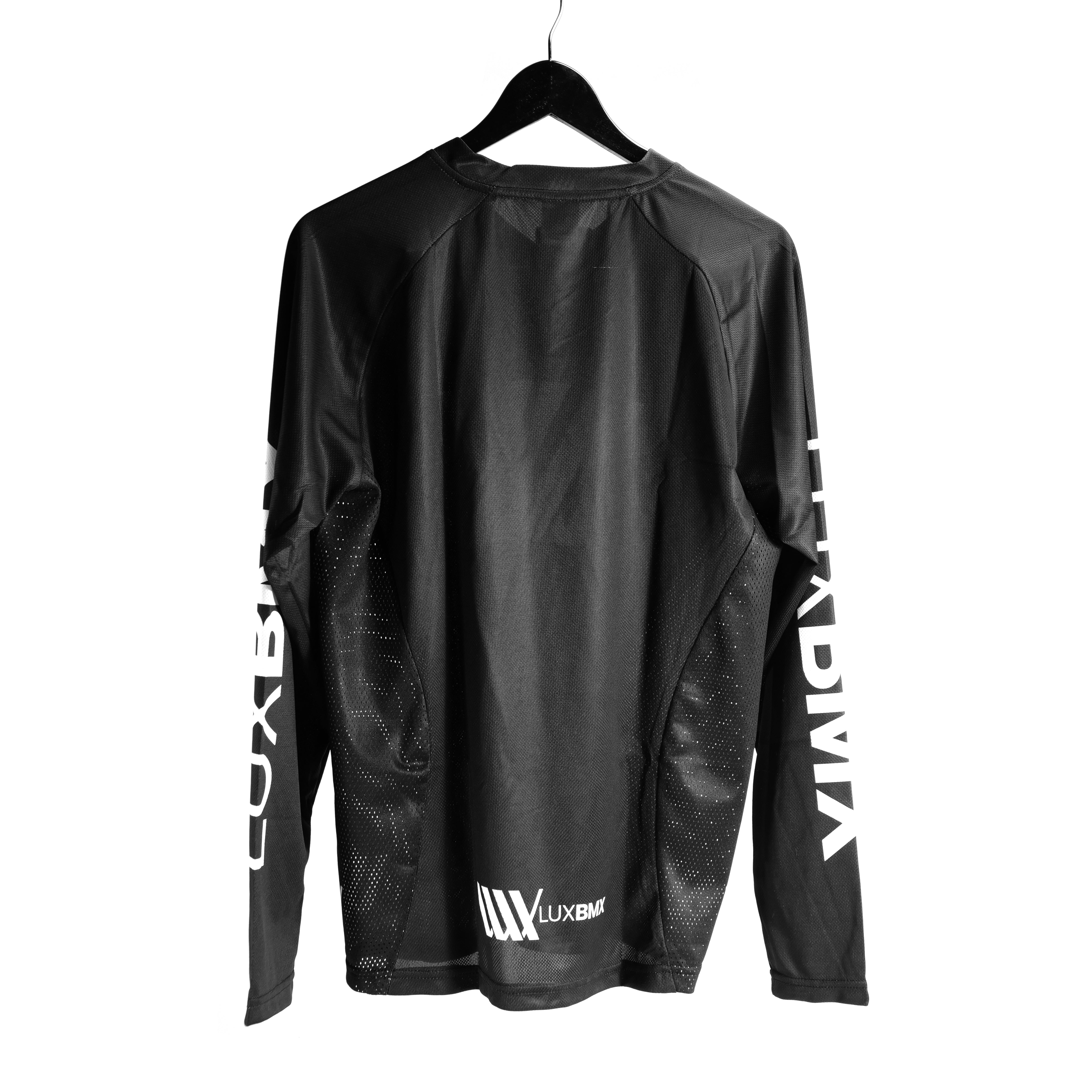 The LUXBMX Race Jersey Black/White V2 features long sleeves with "LUXXBM" printed on both sleeves and the back while hanging on a hanger.