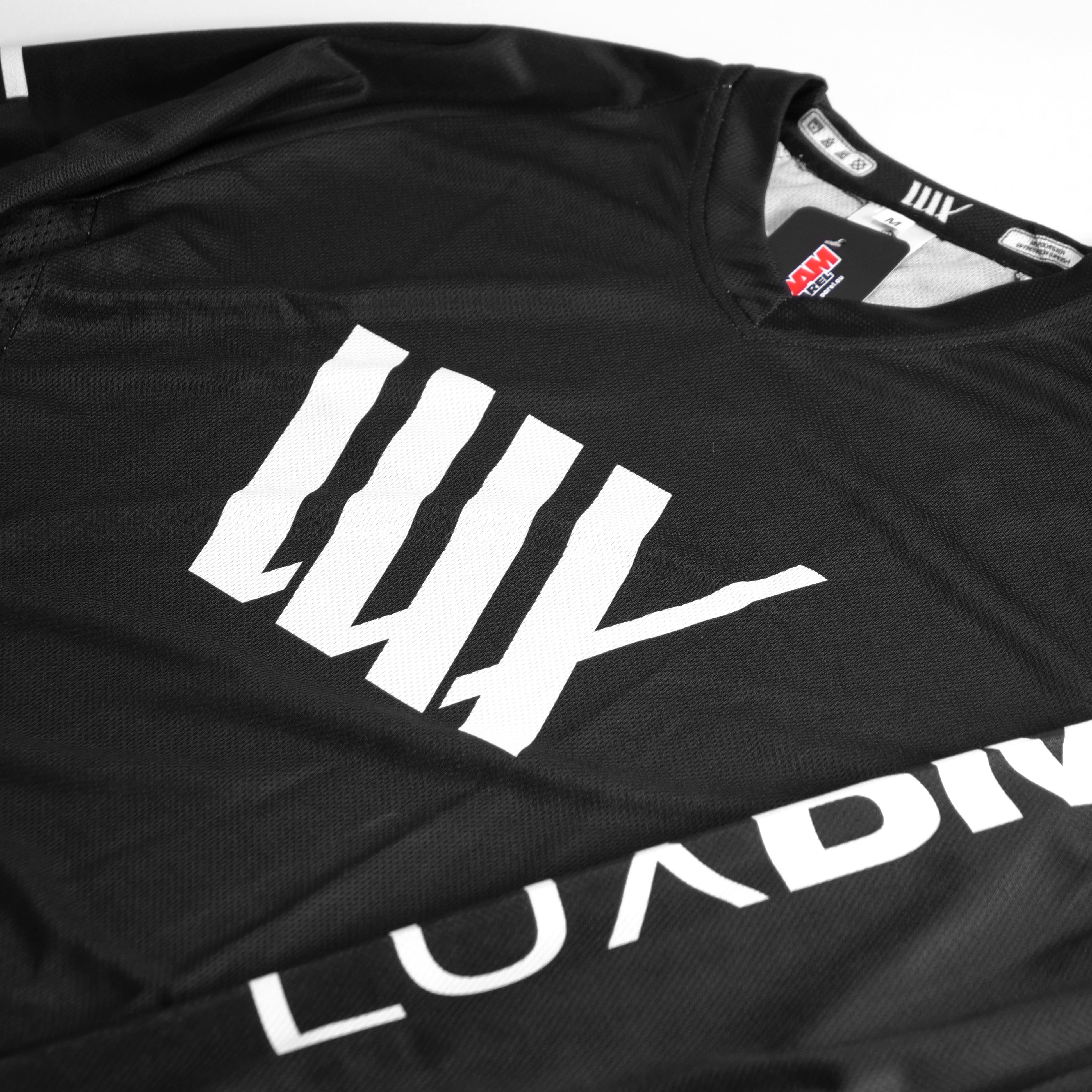 A LUXBMX Race Jersey Black/White V2 featuring black fabric with white stripes and "LUXBMX" text.