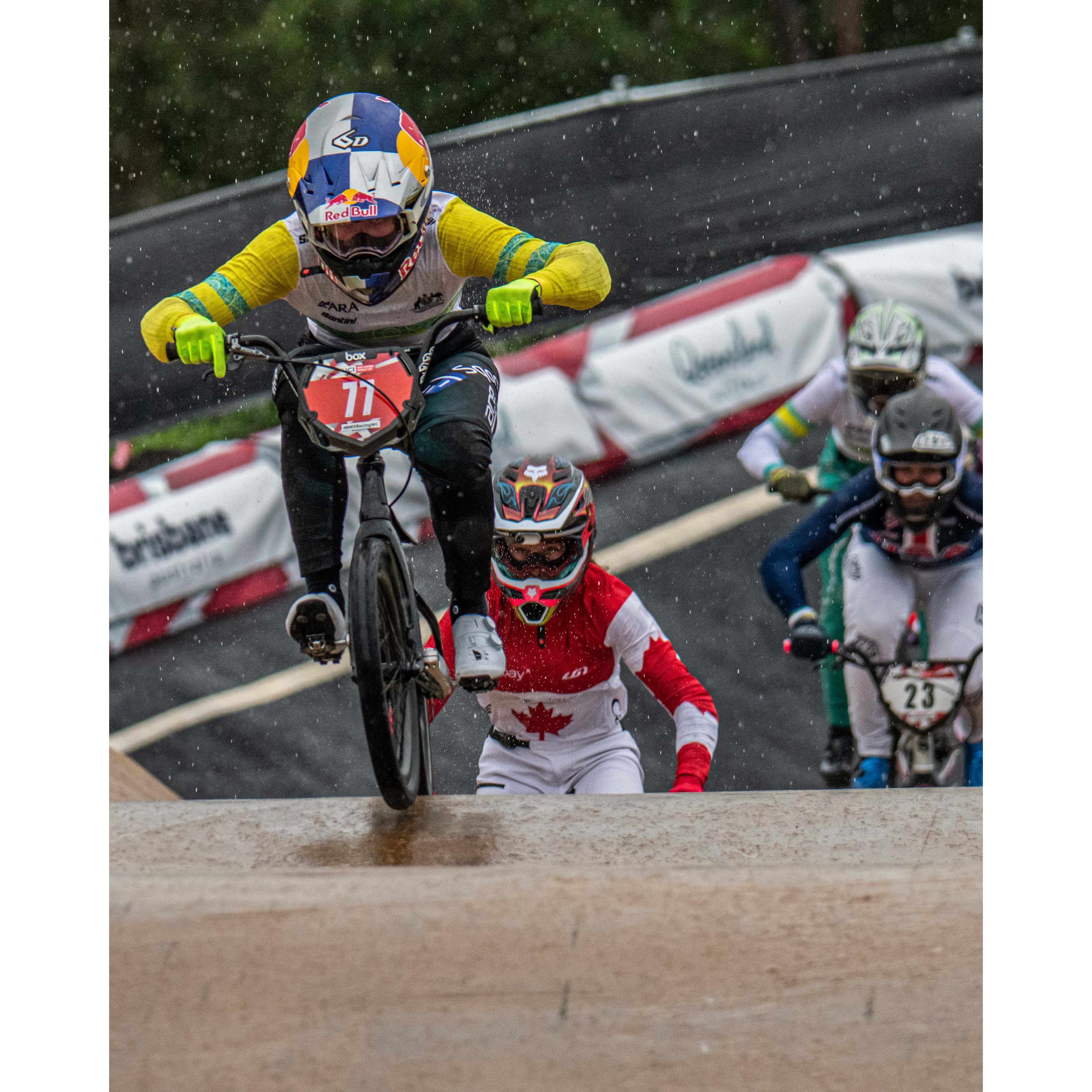 Capture the action from the Lake Macquarie National Series May 2025 with LUXBMX Race Photo Packages—dynamic shots of BMX cyclists competing on a wet track, featuring riders in colorful uniforms and thrilling race moments.