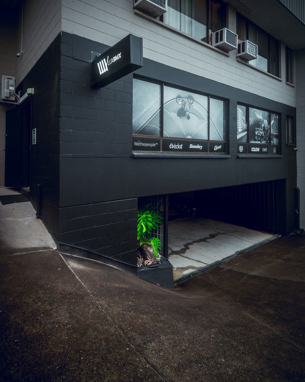 The LUXBMX shopfront: a black corner building with the LUXBMX sign above the windows