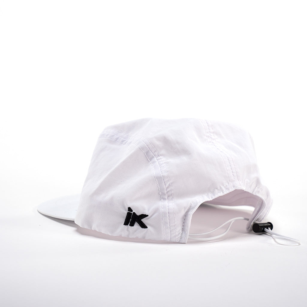 An LUXBMX X IK Aero 5 Panel Cap - White with a black logo on it.