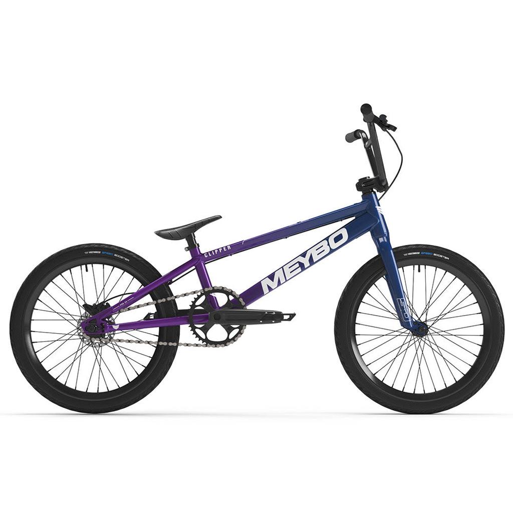 The Meybo 2025 Clipper Pro XXL is a BMX race bike with a purple and blue frame, thick tires, a small seat, and a single gear.