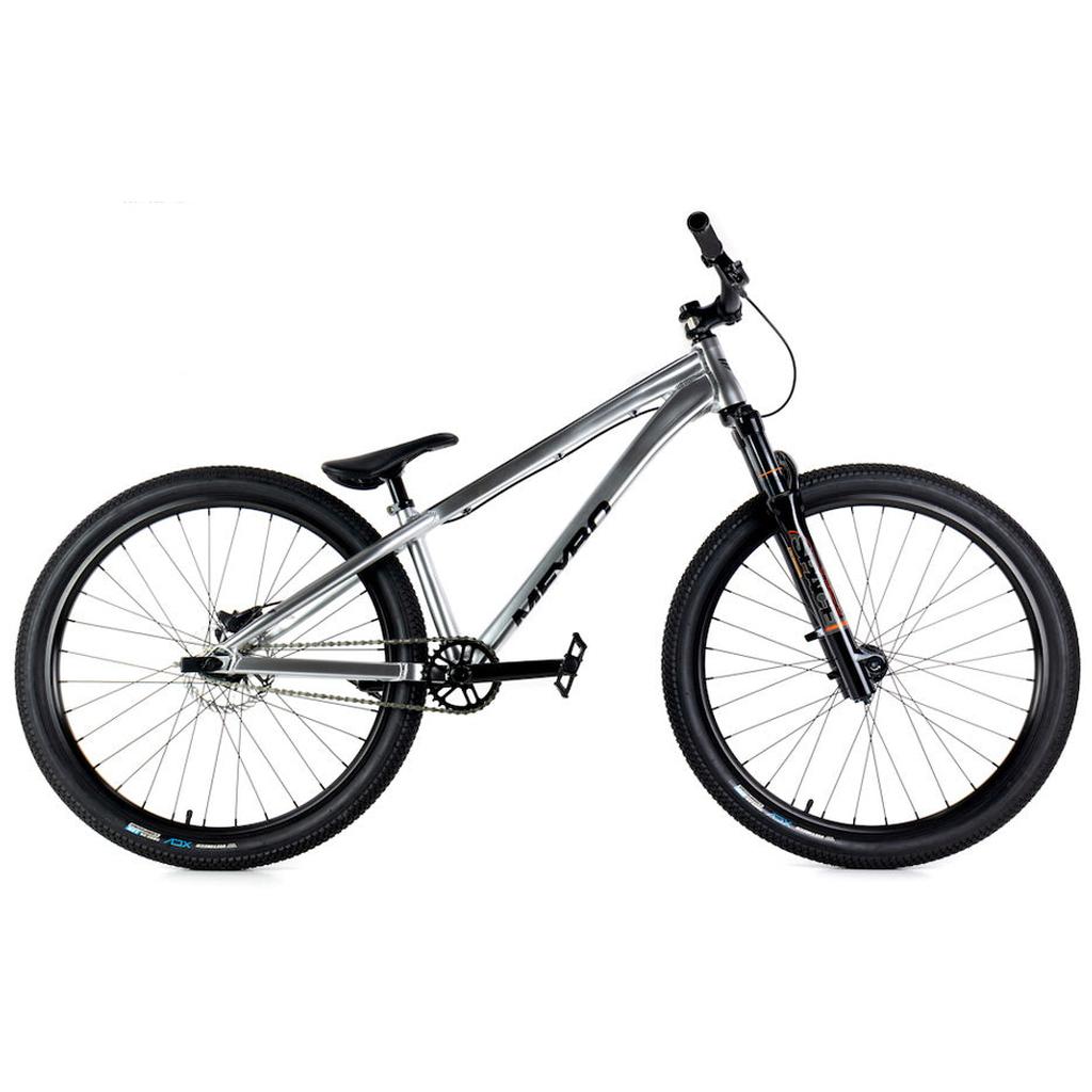 The Meybo 2025 Steez 26 Inch Jump Bike, shown in profile against a white background, features a silver alloy frame, front suspension fork, single gear, flat handlebars, and large knobby tires—ideal for dirt jumping or BMX riding.