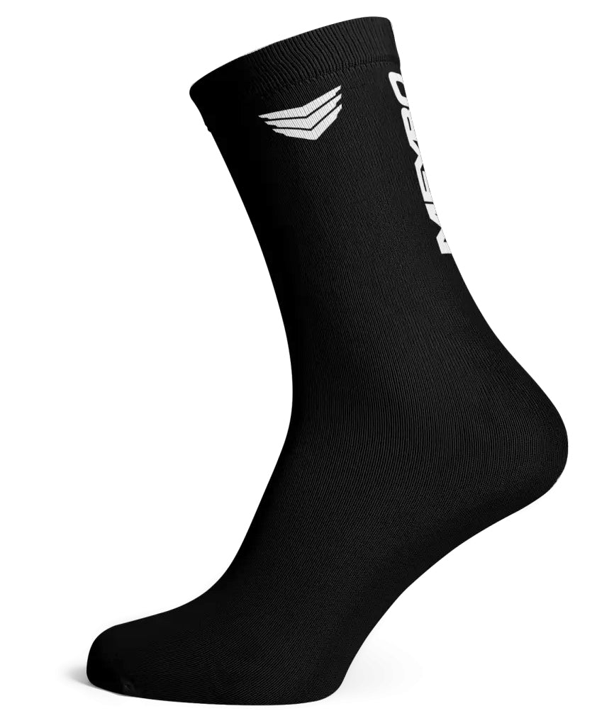 The Meybo Ribbed Crew Sock in black features a white logo and chevron by the upper cuff, shown on an angled mannequin foot against a white background—ideal for racing or showing your style.
