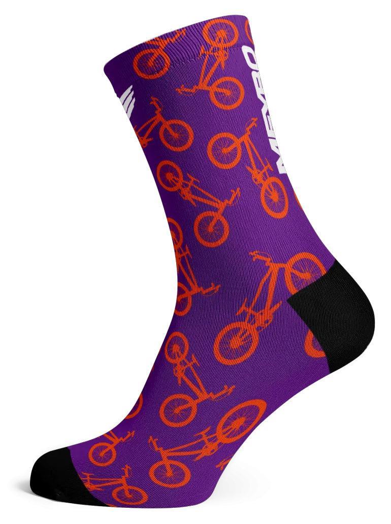 The Meybo Sock Ribbed Crew Sock in purple features an orange bicycle pattern with black heel and toe accents—ideal for racing or standing out on the dance floor.