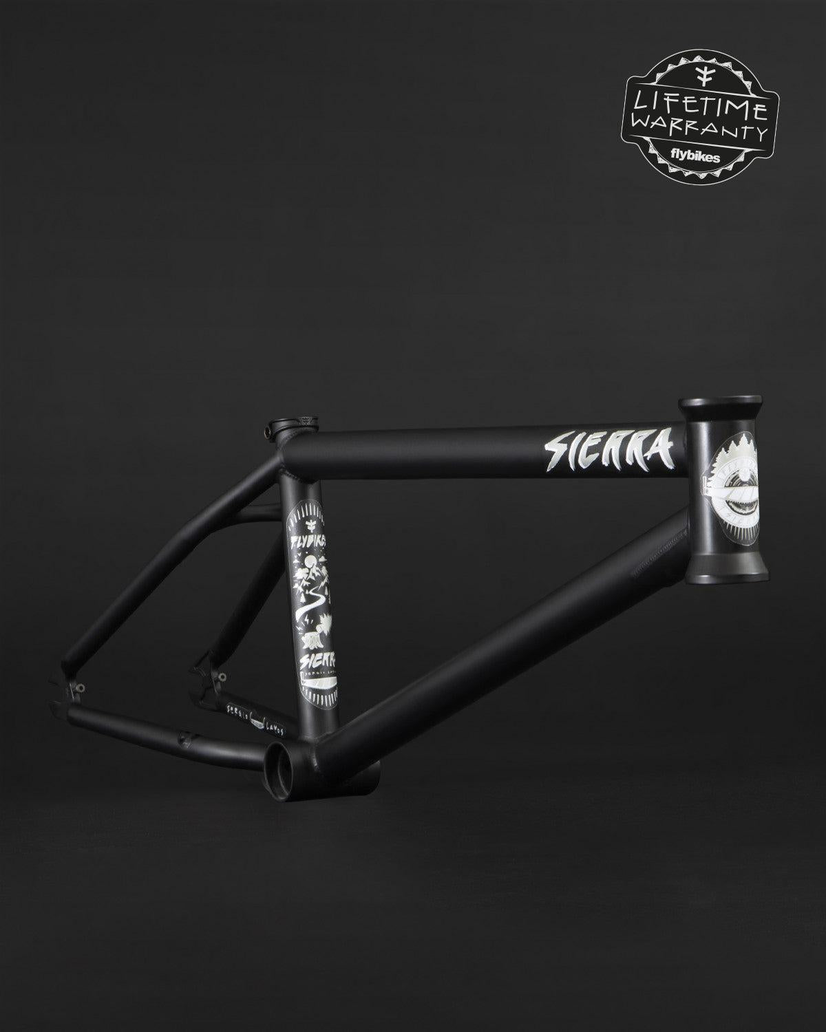 Fly Bikes Sierra 18" frame displays graphic designs on a dark background and includes a "Lifetime Warranty" badge at the top right.