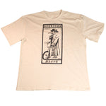 The Nothing's Wrong Plague T-Shirt is a beige tee featuring a hand-printed graphic of a person in a hat and coat on a bike, framed by "NOTHING'S WRONG" and roman numerals.