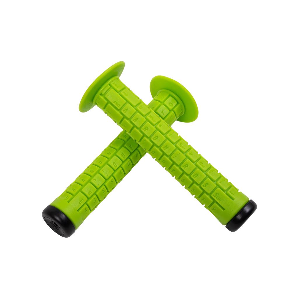 Two bright green Odyssey Aaron Ross Grips, each 145mm long with textured surfaces and black ends, are crossed on a white background—delivering the softest grip for your ride.