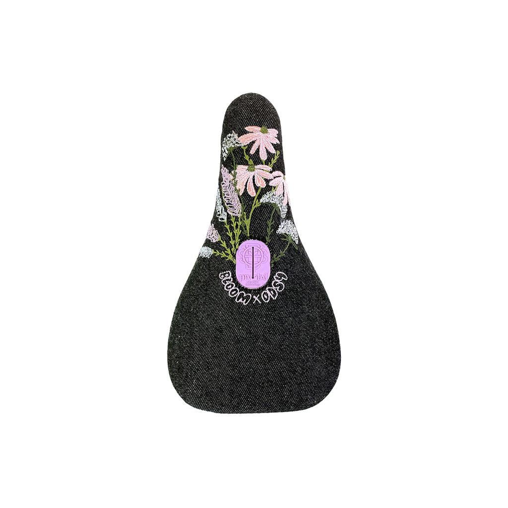 Odyssey Bloom Pivotal Seat decorated with embroidered pink floral design and the text "bloom xoxo" on a white background.