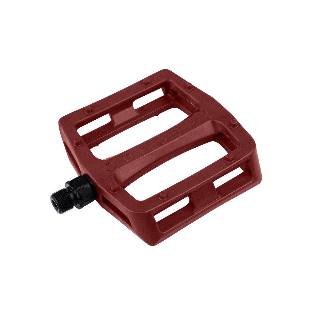 A slim profile pedal, the Odyssey Grandstand V2 Nylon Pedals (Tom Dugan), featuring a vibrant red color against a matching background.