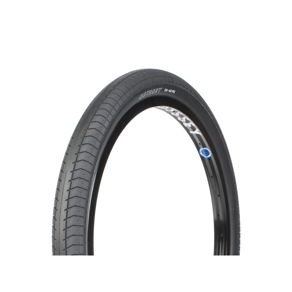 A close-up image of a black bicycle tire, showcasing the superior grip provided by the Odyssey Path Pro 24 Inch Tyre's unique tread pattern and proprietary rubber compound.