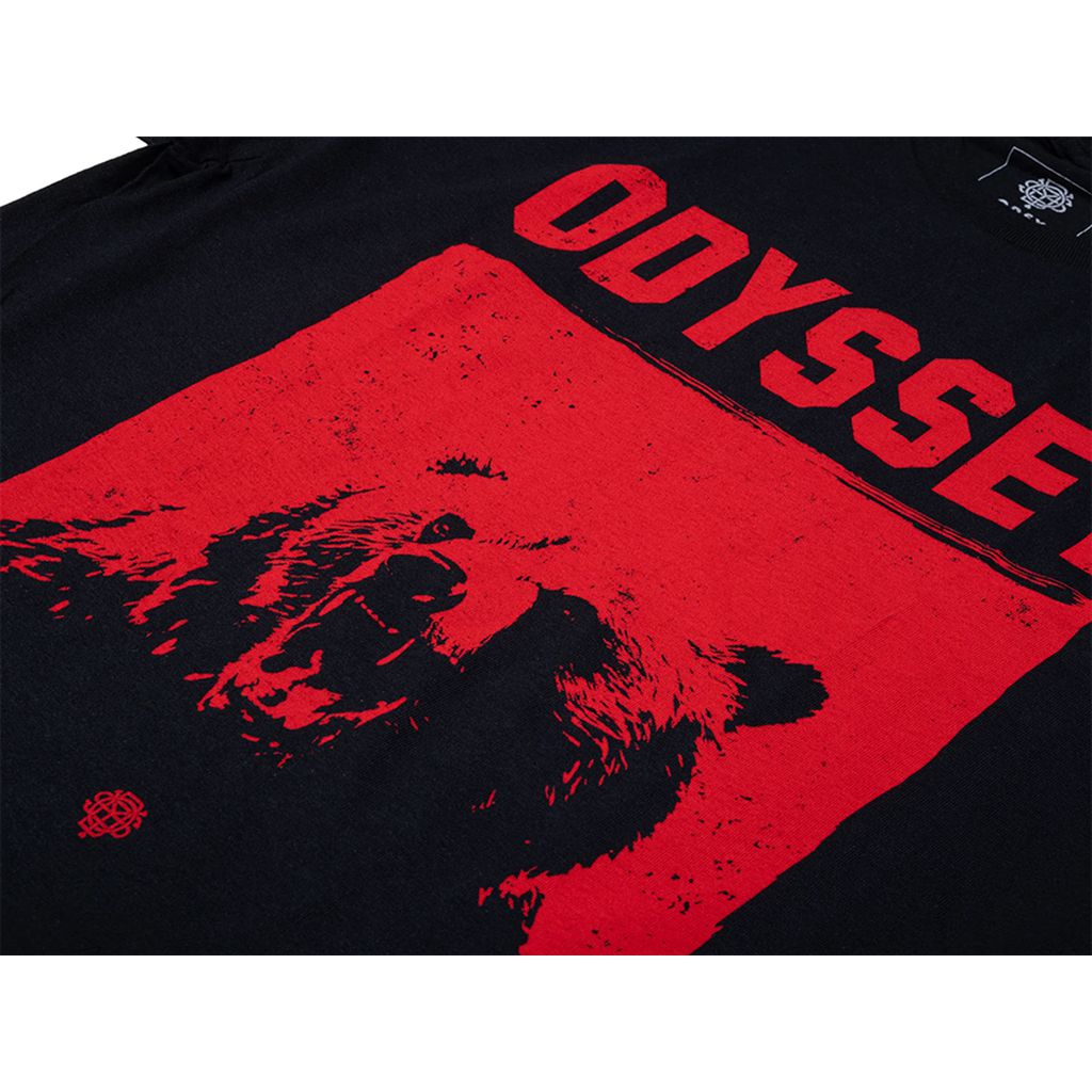 The Odyssey Seeing Red T-Shirt is a black t-shirt showcasing a striking red graphic of a bear's face with the word "Odyssey" prominently displayed in large capital letters above it—a perfect choice for those who embrace their wild side.