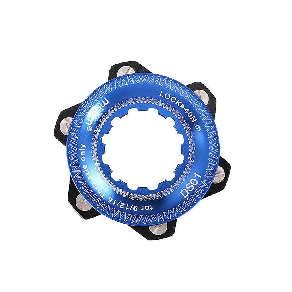 The Position One Centerlock ISO Adapter Kit includes a blue and black lockring tool with a 40 Nm torque specification, multiple bolts, and an asymmetric, gear-like interior opening, ideal for installing Center Lock Adapters.