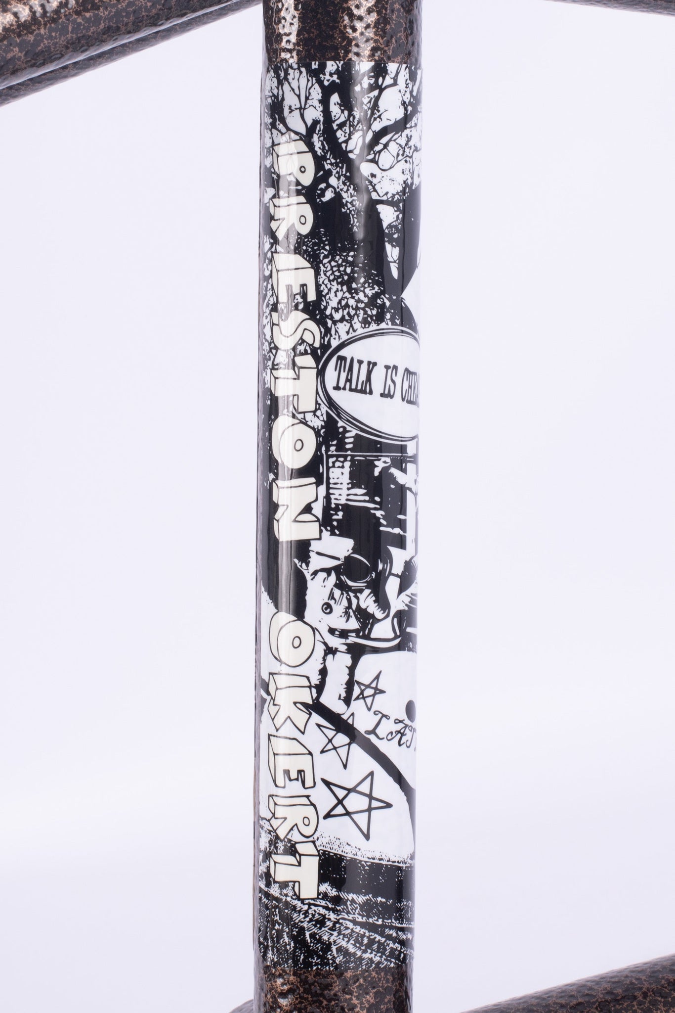 A close-up of the Cult Walsh Frame (Preston Okert Signature) BMX, showcasing its black and white graphics, "TALK IS CHEAP" text, signature details, and distinctive symbols.