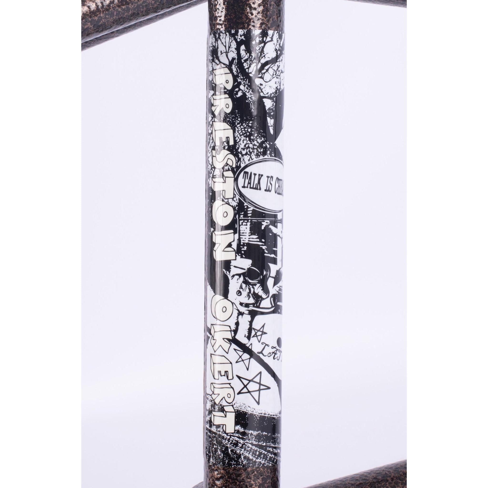 A close-up of the Cult Walsh Frame (Preston Okert Signature) BMX, showcasing its black and white graphics, "TALK IS CHEAP" text, signature details, and distinctive symbols.
