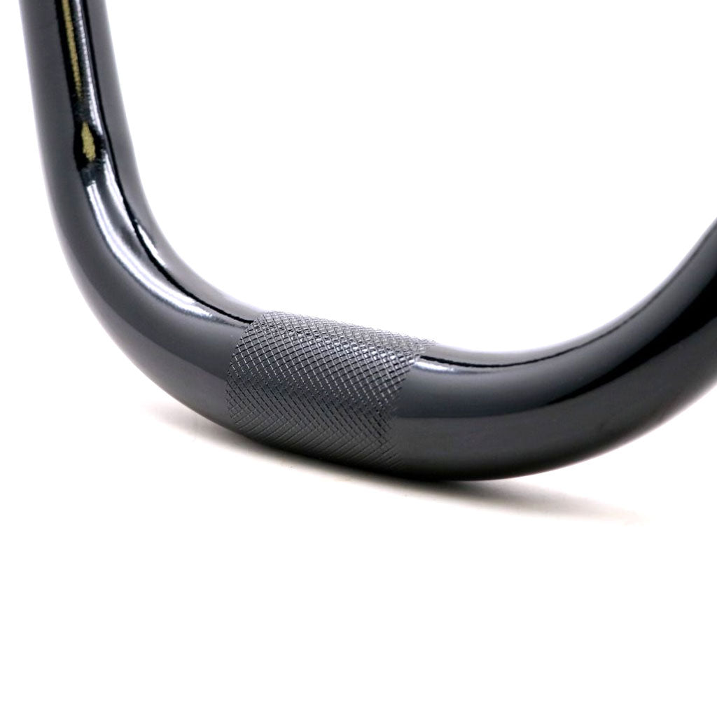 A close up of a PRIDE Flowmotion V2 31.8 Bar on a white surface, showcasing its rigidity.