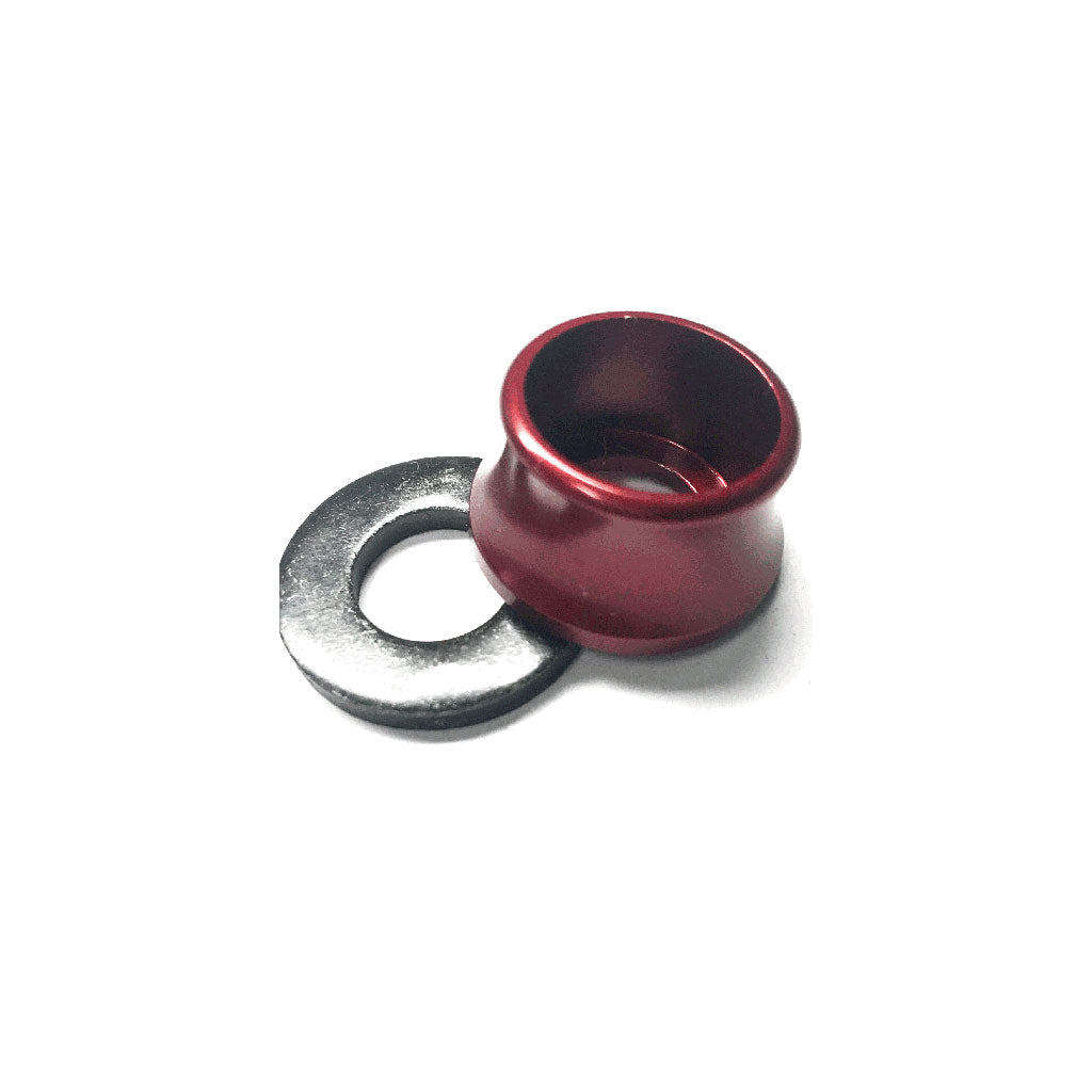 A red metal spool pin cap sits next to a sleek silver Profile Axle Volcano Washer Alloy-Steel on a pristine white background.