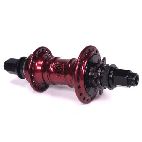 The Profile Mini Rear Cassette Hub, in red, showcases a BMX hub design featuring multiple holes and sleek black threaded axles on each end, enhanced by its elegant low-flange style.