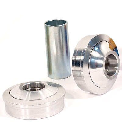 Three metal machined parts, including two round components with central holes and one cylindrical piece, displayed on a white background, resembling elements from a Profile USA Bottom Bracket Kit tailored for American BB shells.