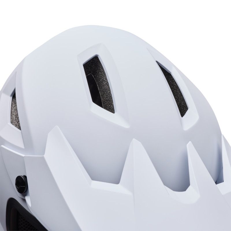Close-up of the top of the Bell Sanction 2 White helmet, an entry-level model with multiple air vents and an angular design.
