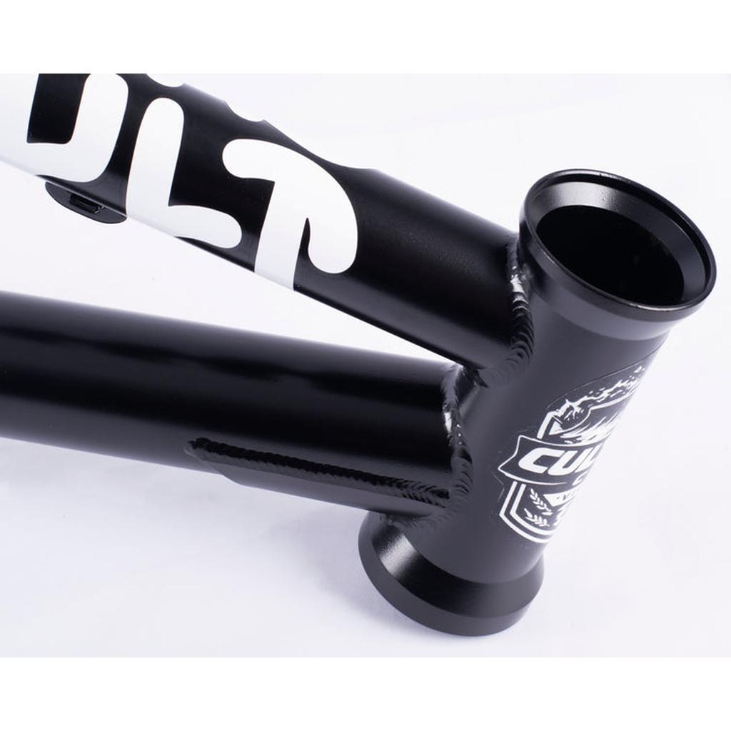 Close-up of the black Cult Race Disc Frame / Pro XXL BMX, made from durable chromoly, with bold white "CULT" lettering and a graphic logo near the head tube.