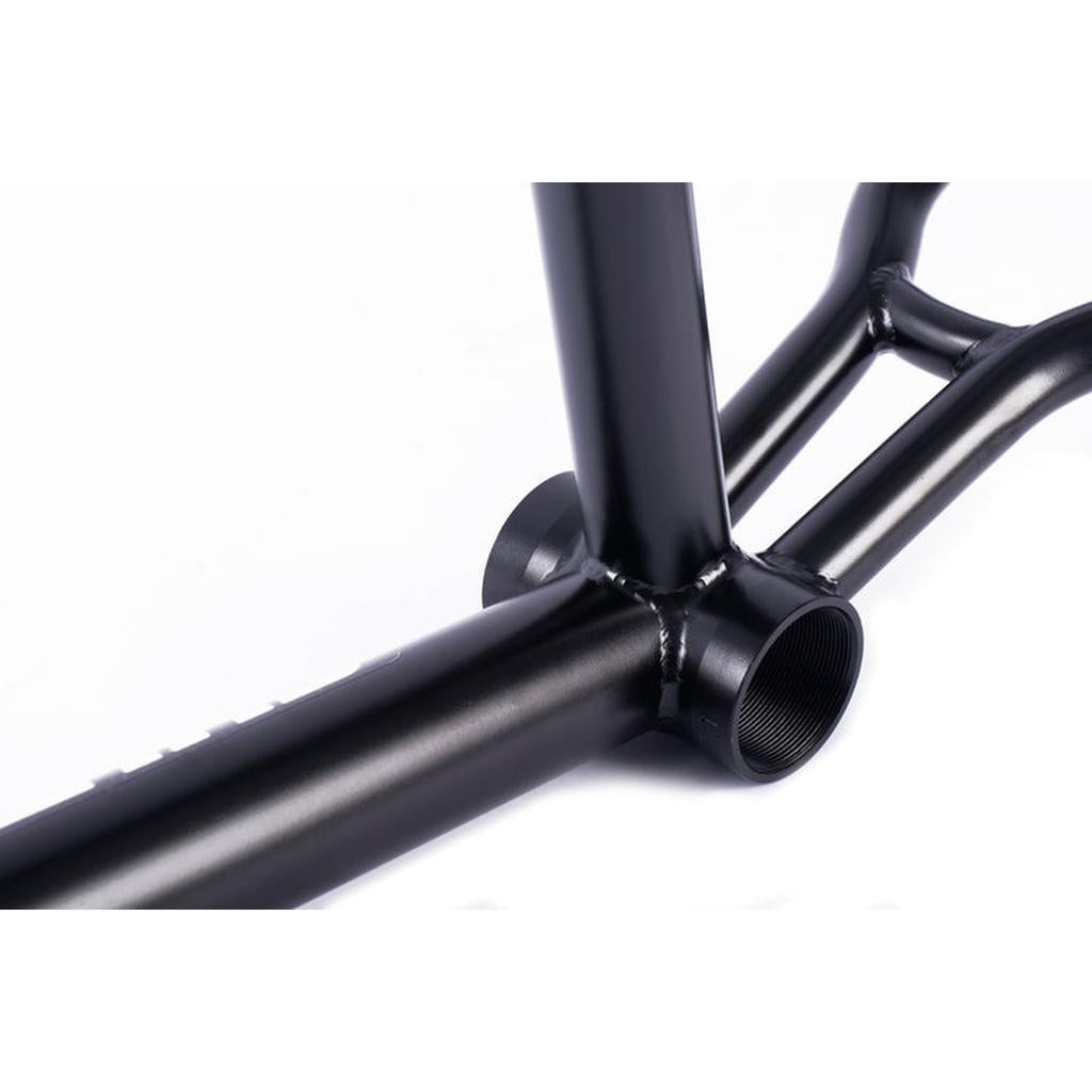 Close-up of the Cult Race Disc Frame / Pro XL in black chromoly, highlighting the bottom bracket and weld joints against a white background.
