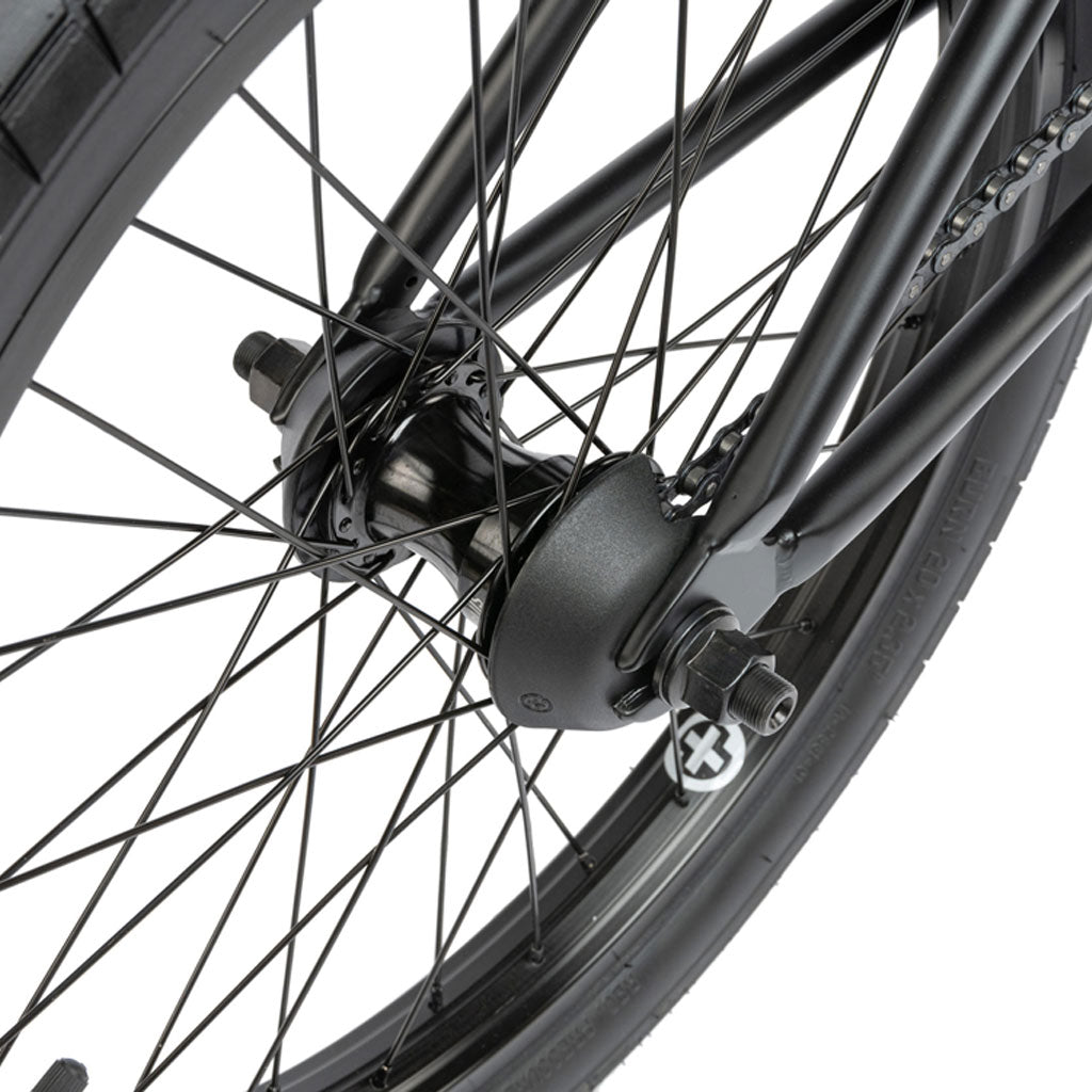 Close-up of a black Radio Comrad 20 inch Bike wheel, highlighting the spokes, hub, and tire, all supported by a sturdy full Cromoly frame for optimal performance.